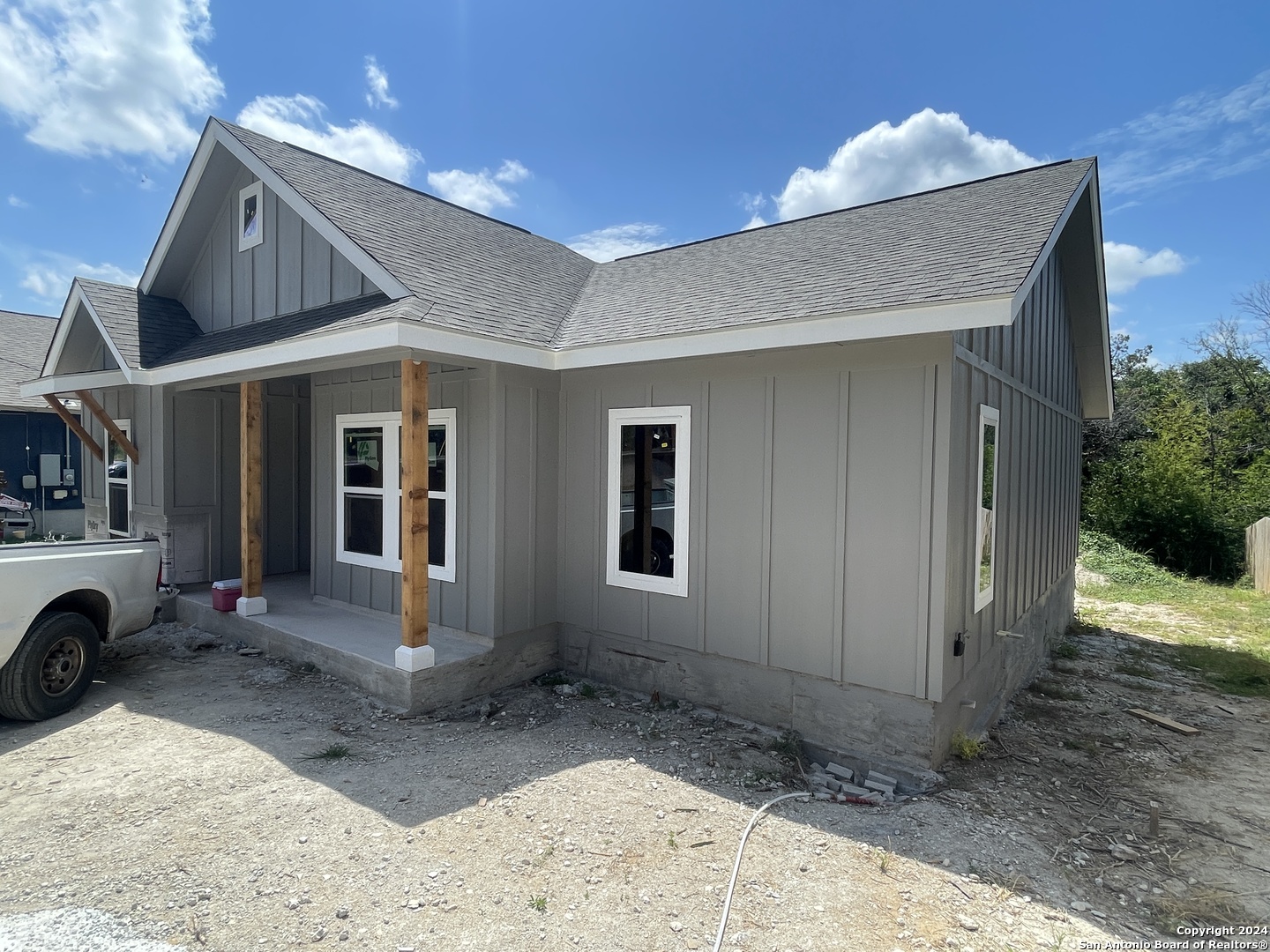 a view of a house with a yard and sitting space