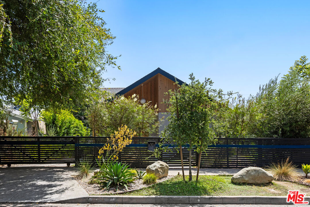 a backyard of a house with lots of green space and fountain