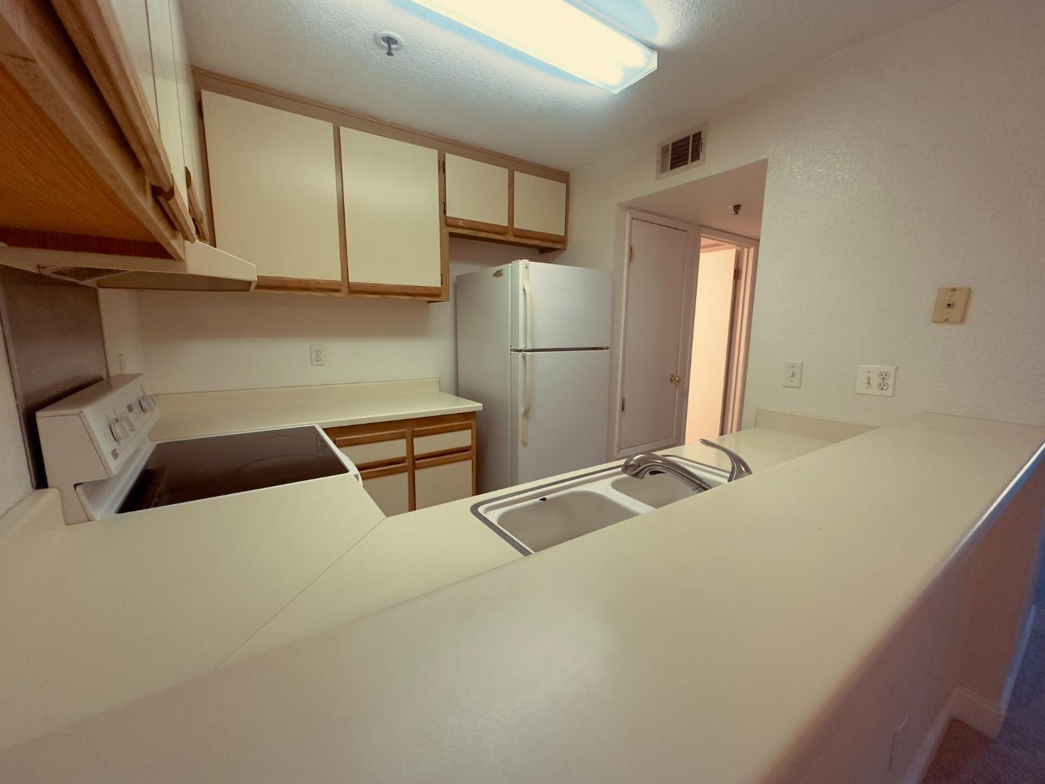 a kitchen with stainless steel appliances a refrigerator and cabinets