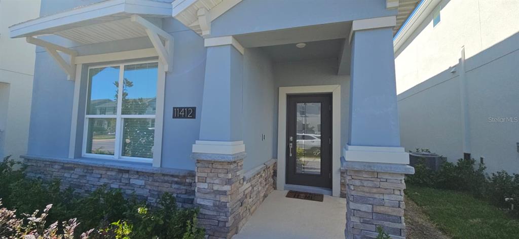 a view of front door of house and yard