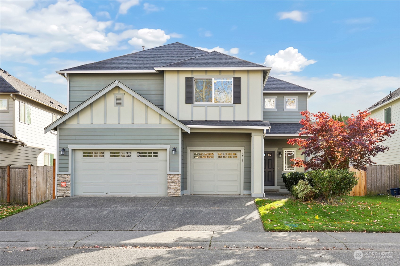 a front view of a house with a yard and garage