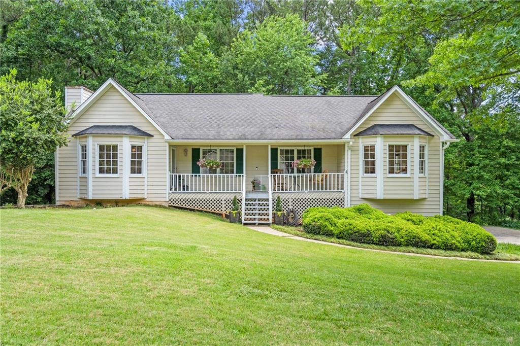 a front view of a house with yard and green space