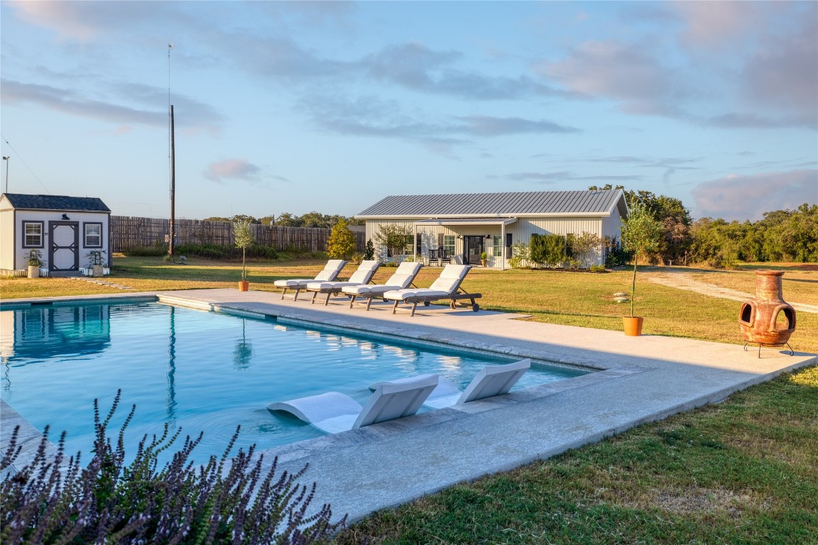 swimming pool view with a lake view