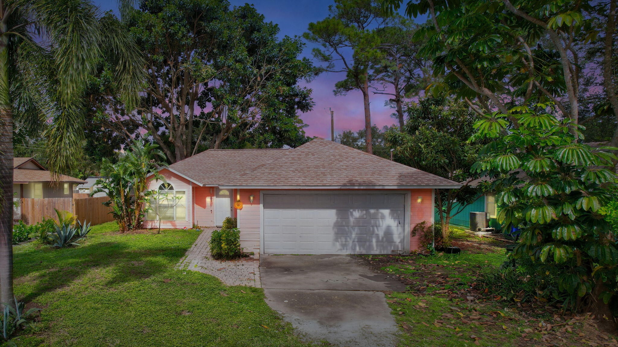 a view of a house with a yard and tree s