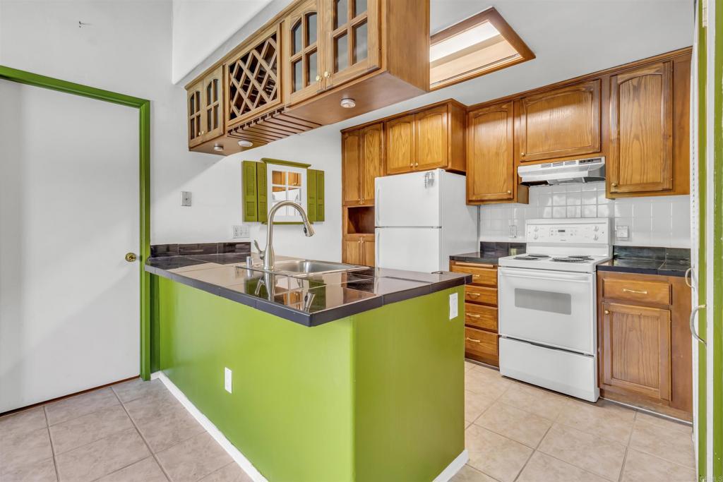 a kitchen with cabinets a island and stainless steel appliances