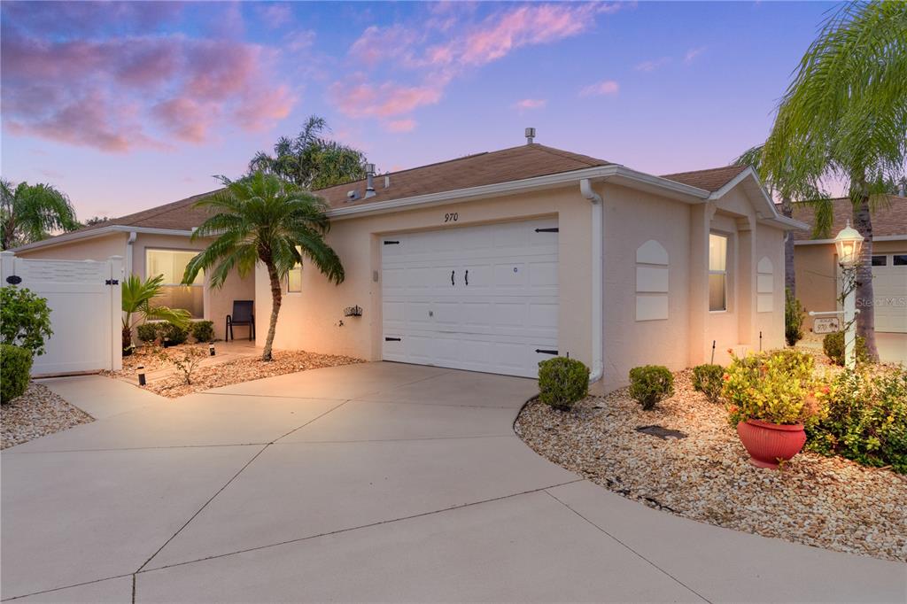 a view of a house with a yard and a garage