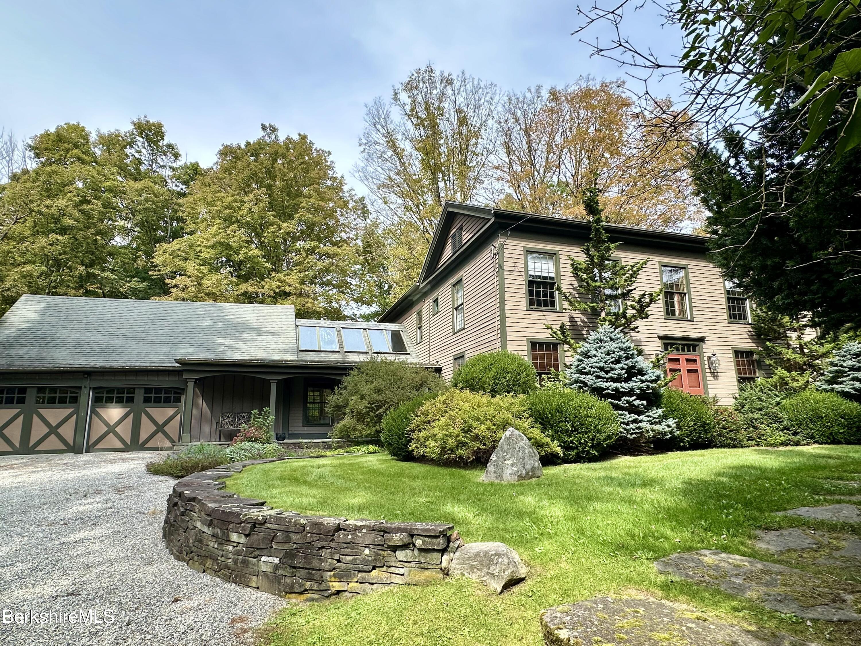 a front view of a house with a yard and porch