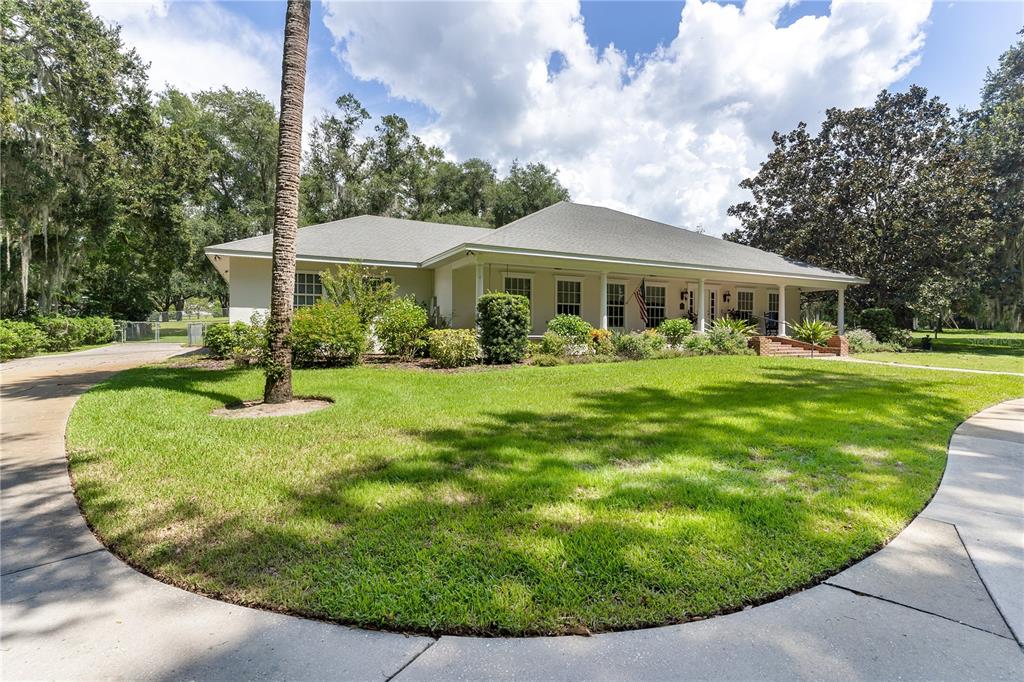 a view of a house with a backyard