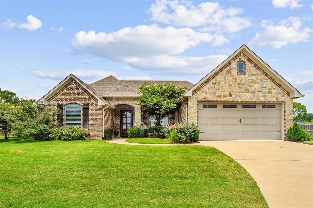 a front view of house with yard and green space