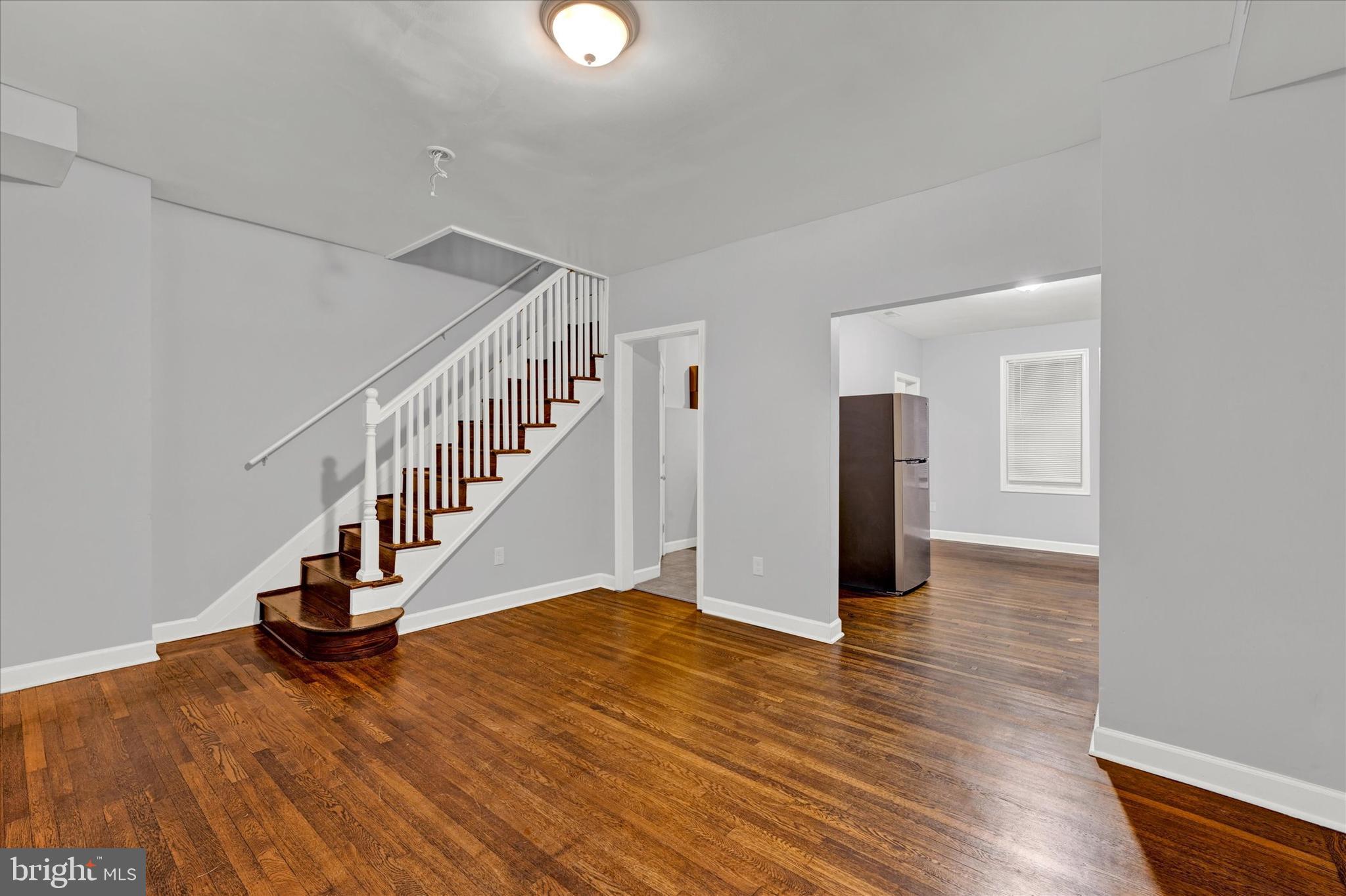 a view of entryway and hall with wooden floor