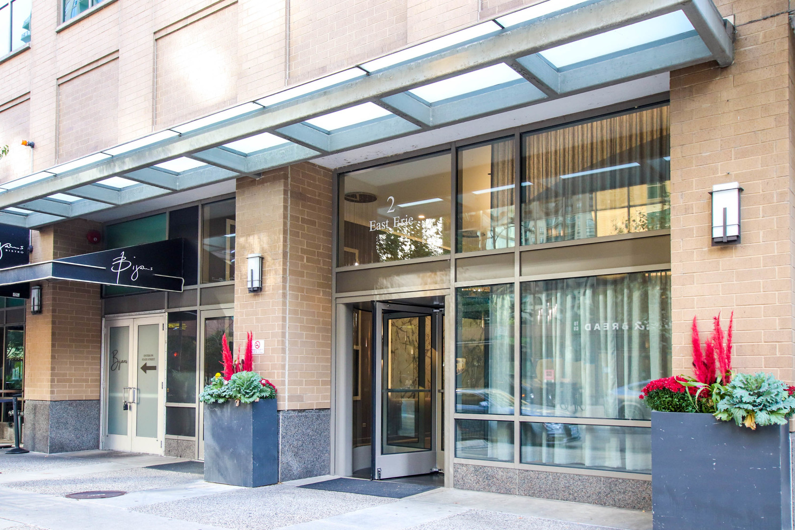 a front view of a building with flowers