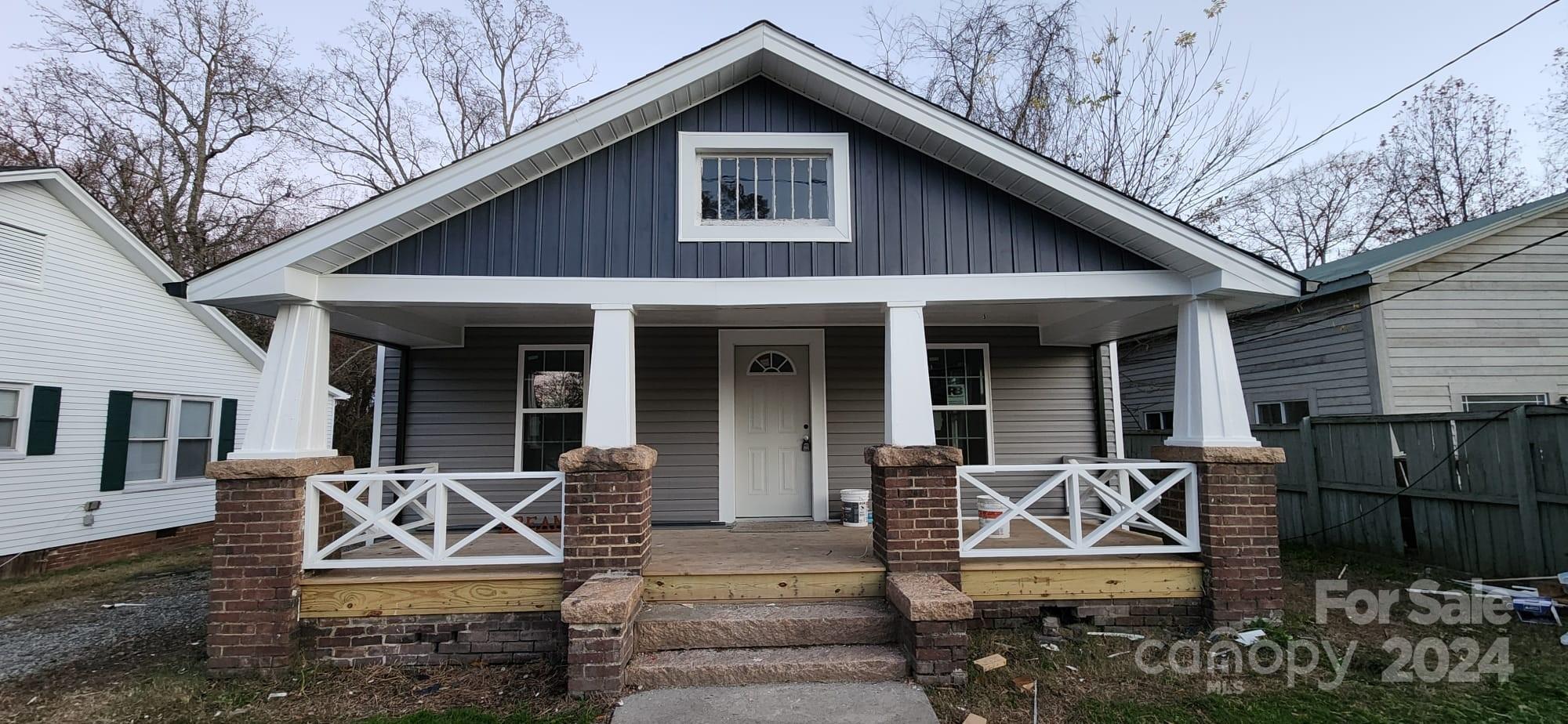 a front view of a house with sitting area