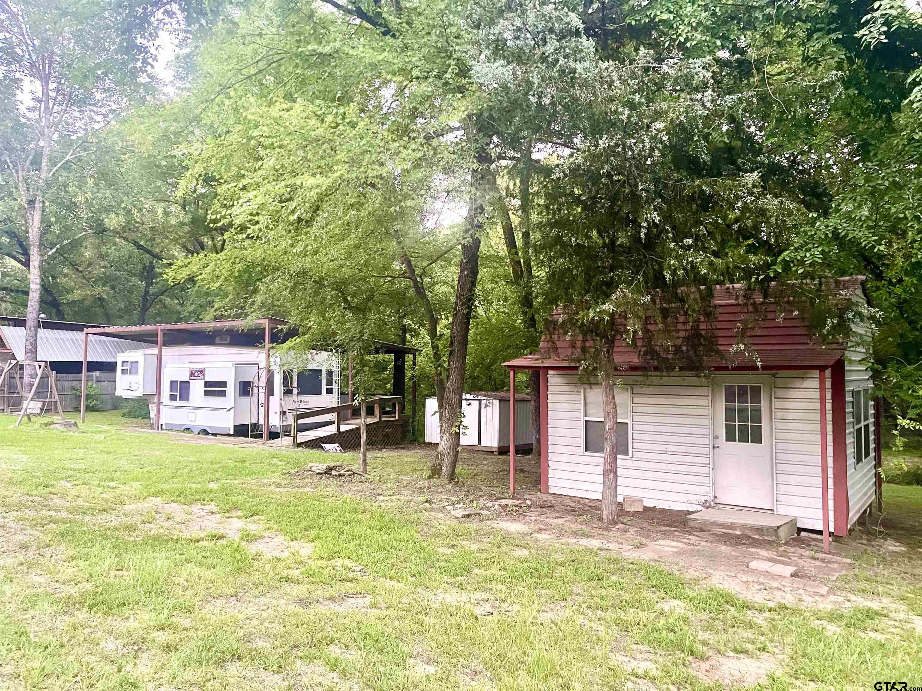 a view of a house with a yard and sitting area