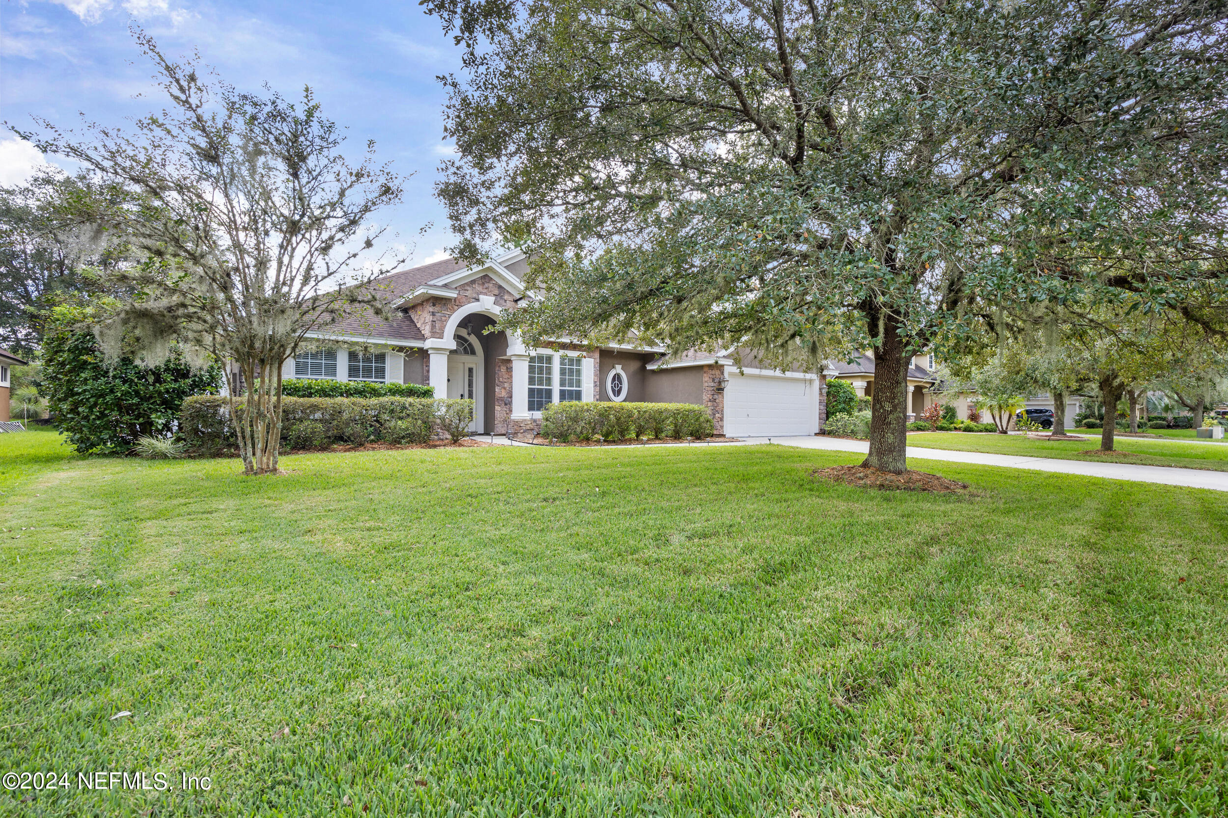 a front view of house with yard and green space