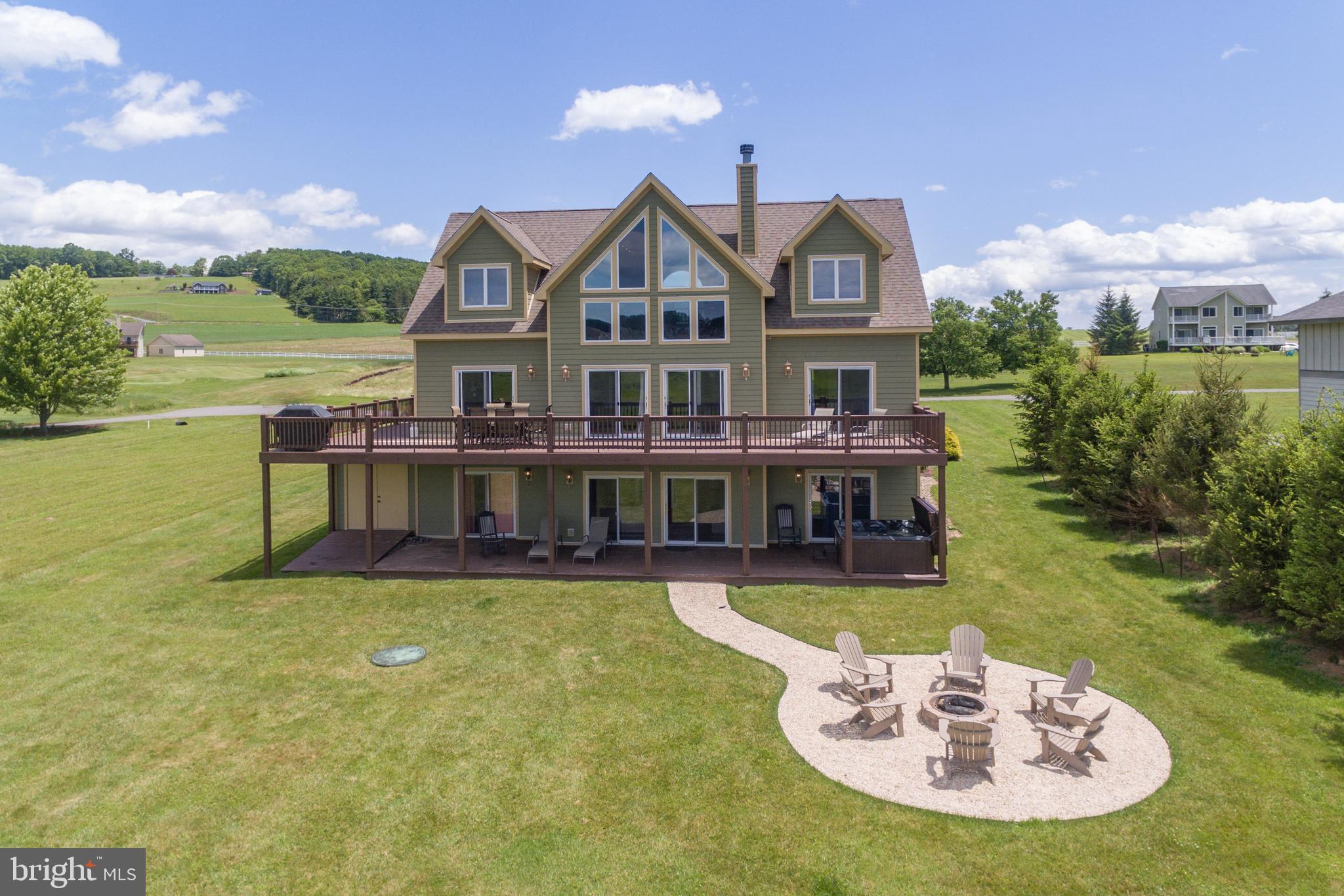 a view of a house with a swimming pool and a yard