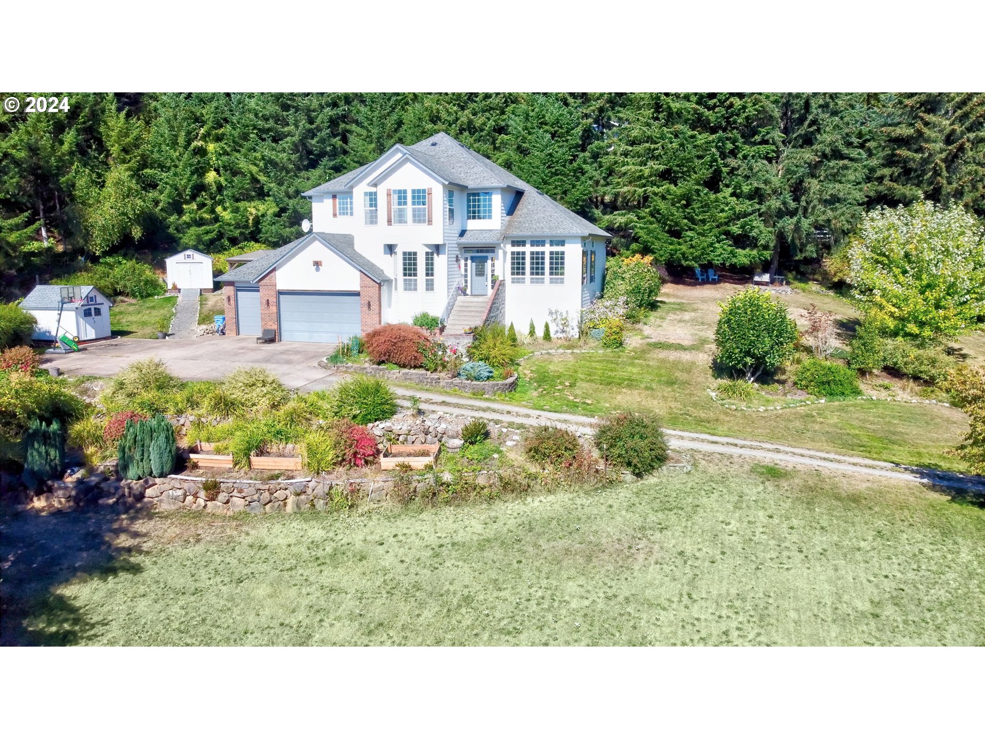 a view of a house with a yard and table