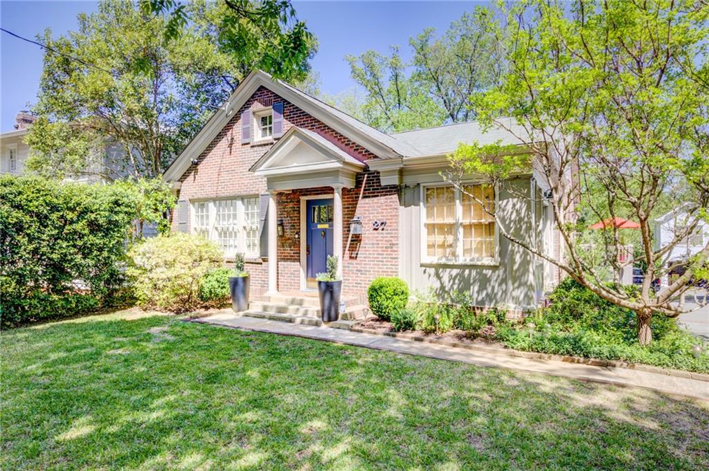 a front view of a house with a yard and porch