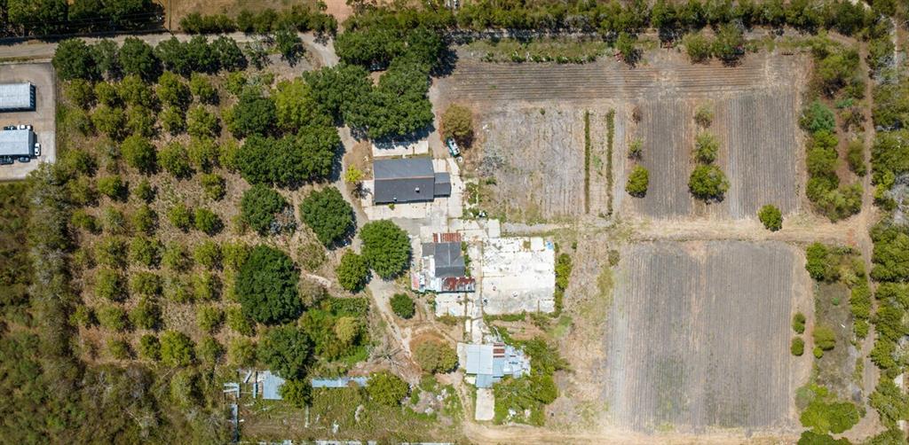 an aerial view of residential house with outdoor space and parking