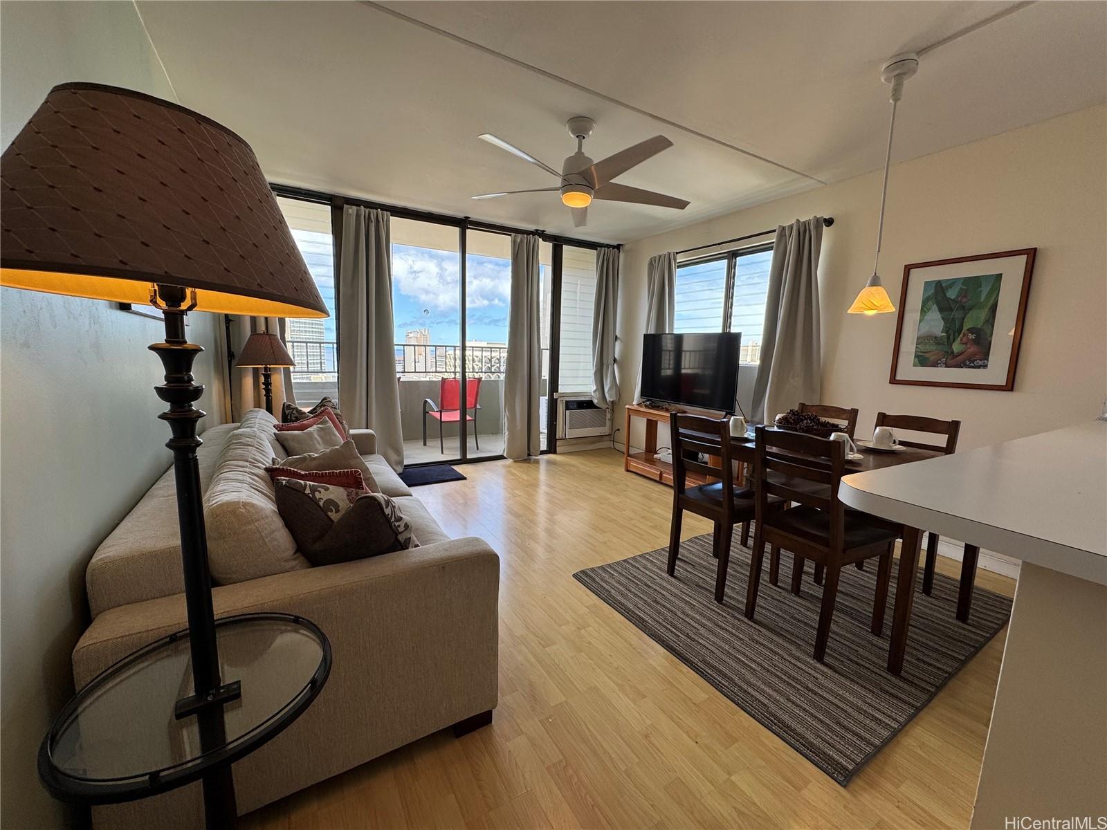 a living room with furniture a flat screen tv and a large window