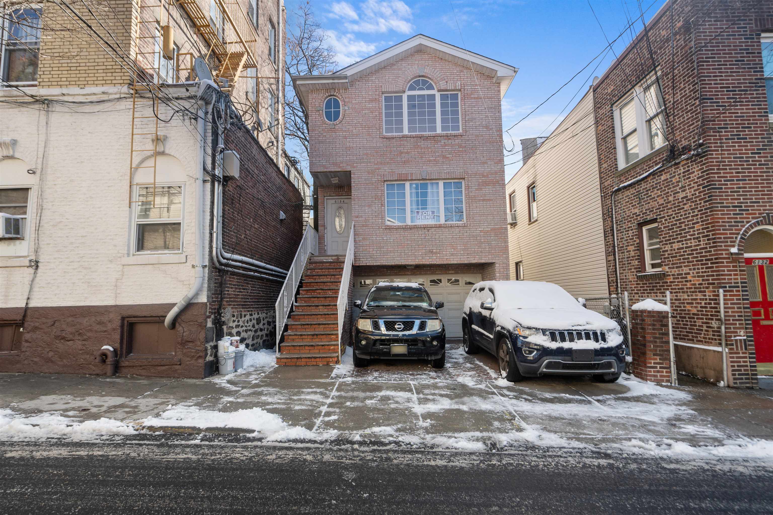 a car parked in front of a brick house