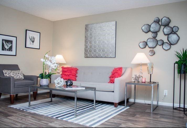 a living room with furniture and wooden floor