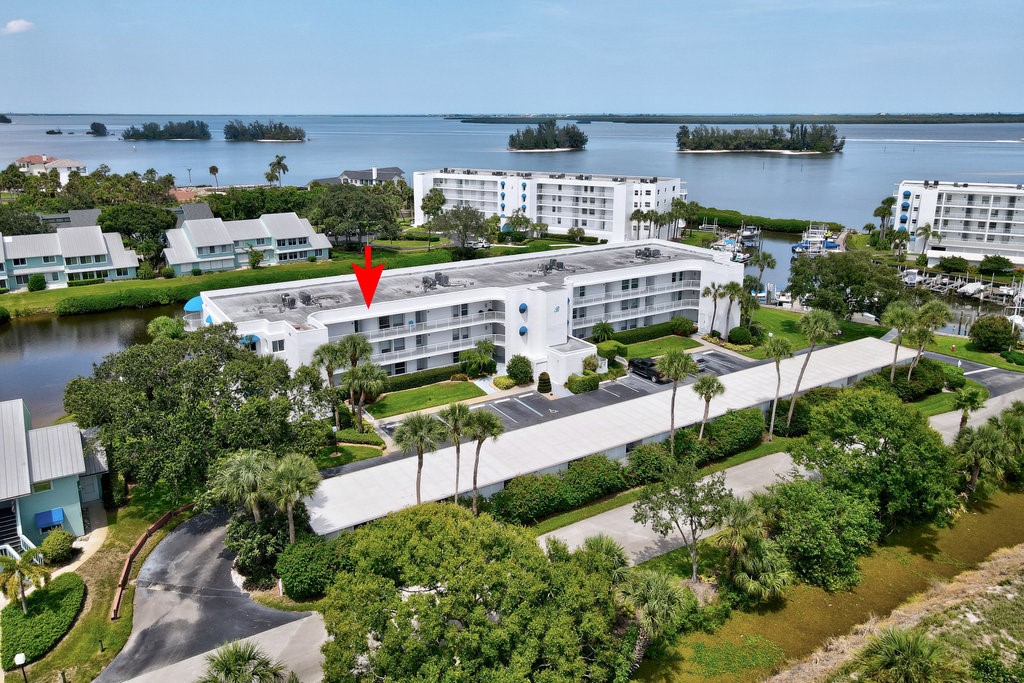 an aerial view of a house with a garden and lake view