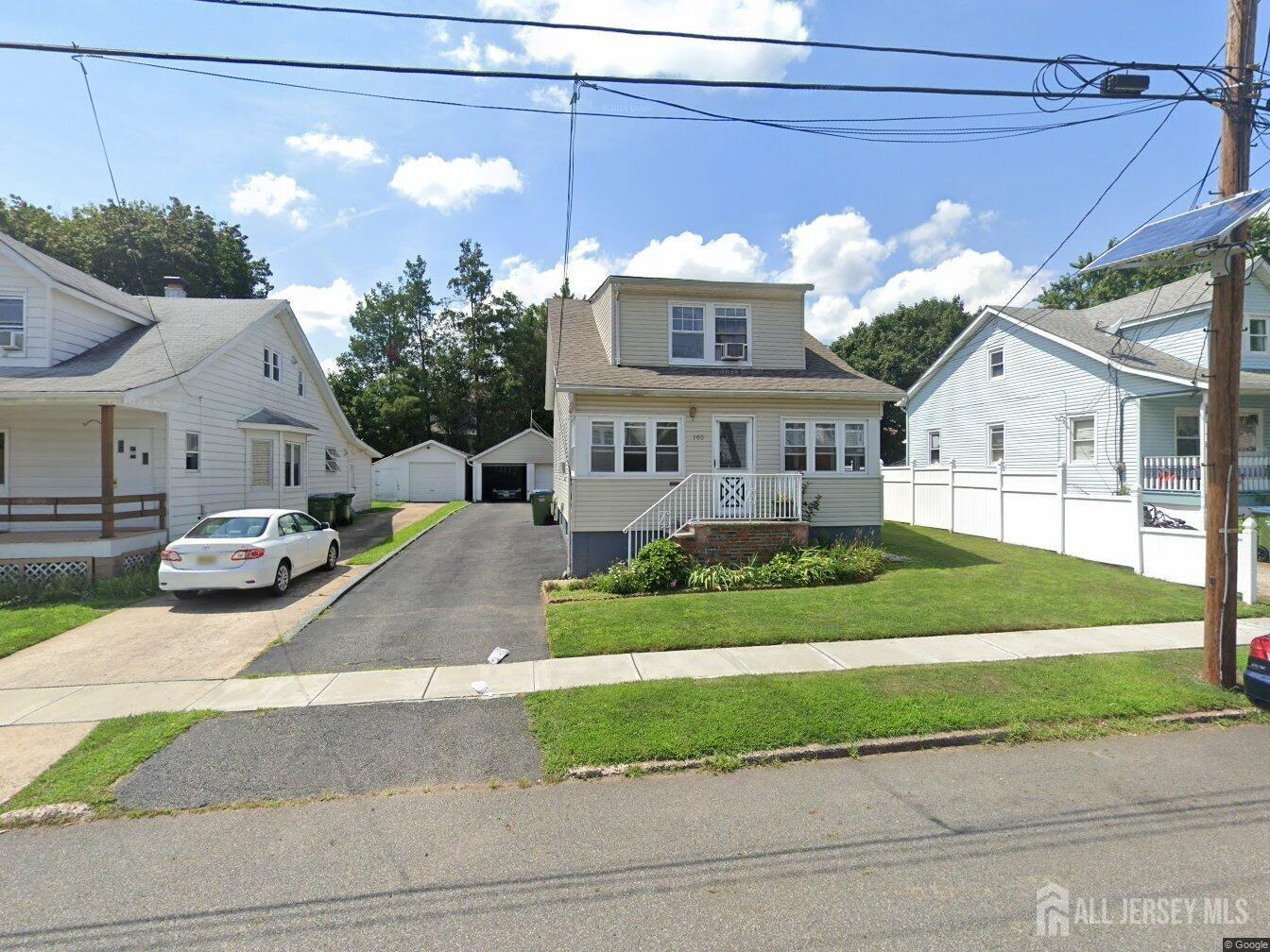 a front view of a house with a garden and plants