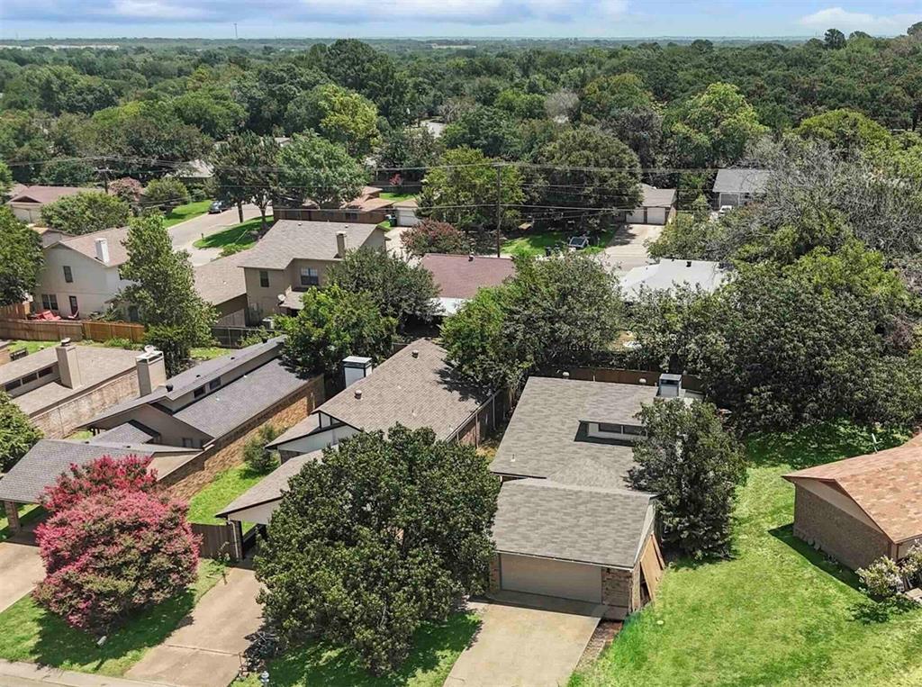 an aerial view of a house with a yard