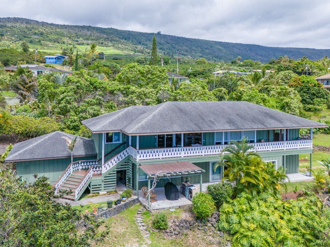 a aerial view of a house next to a yard