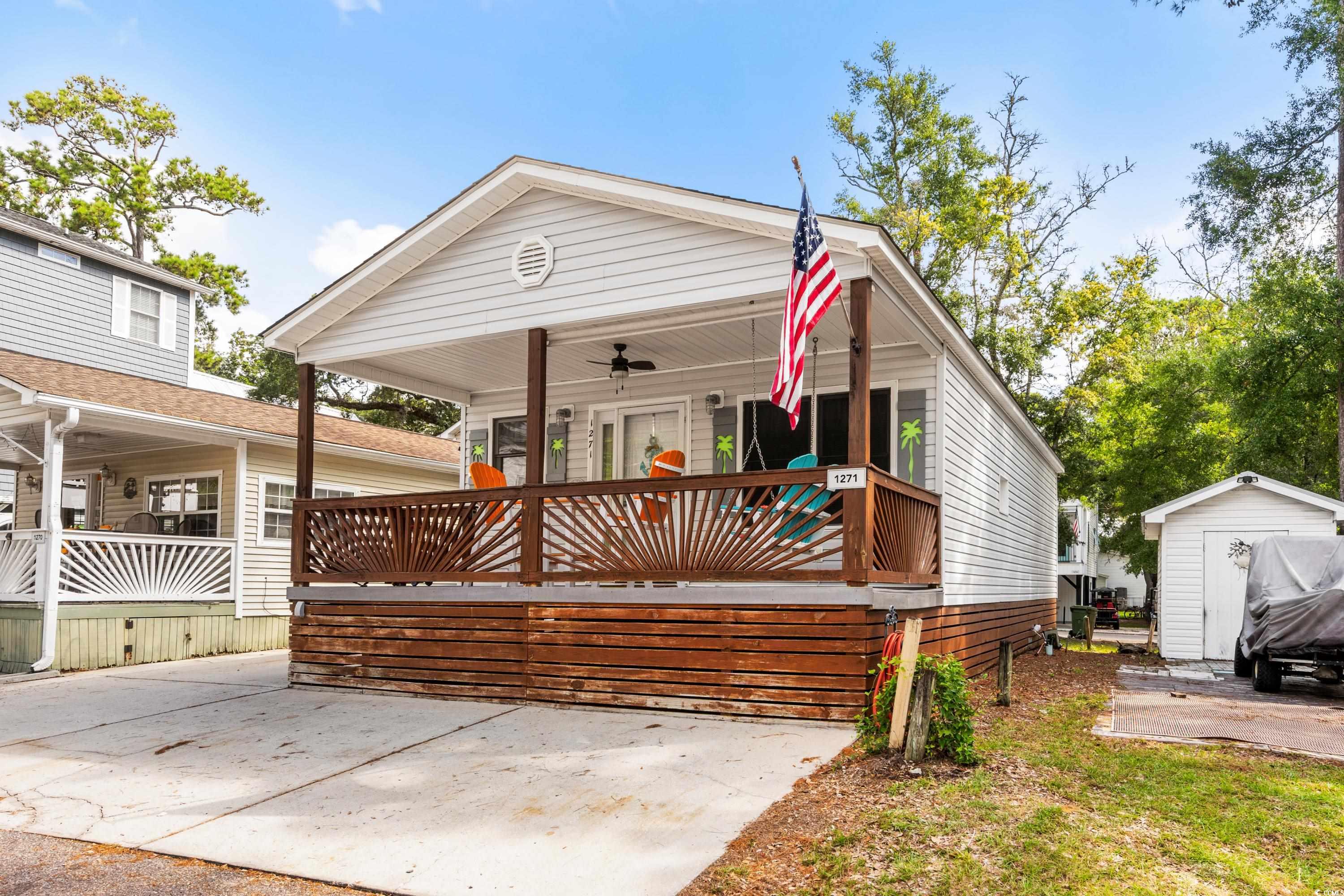 View of front facade with a porch, an outbuilding,