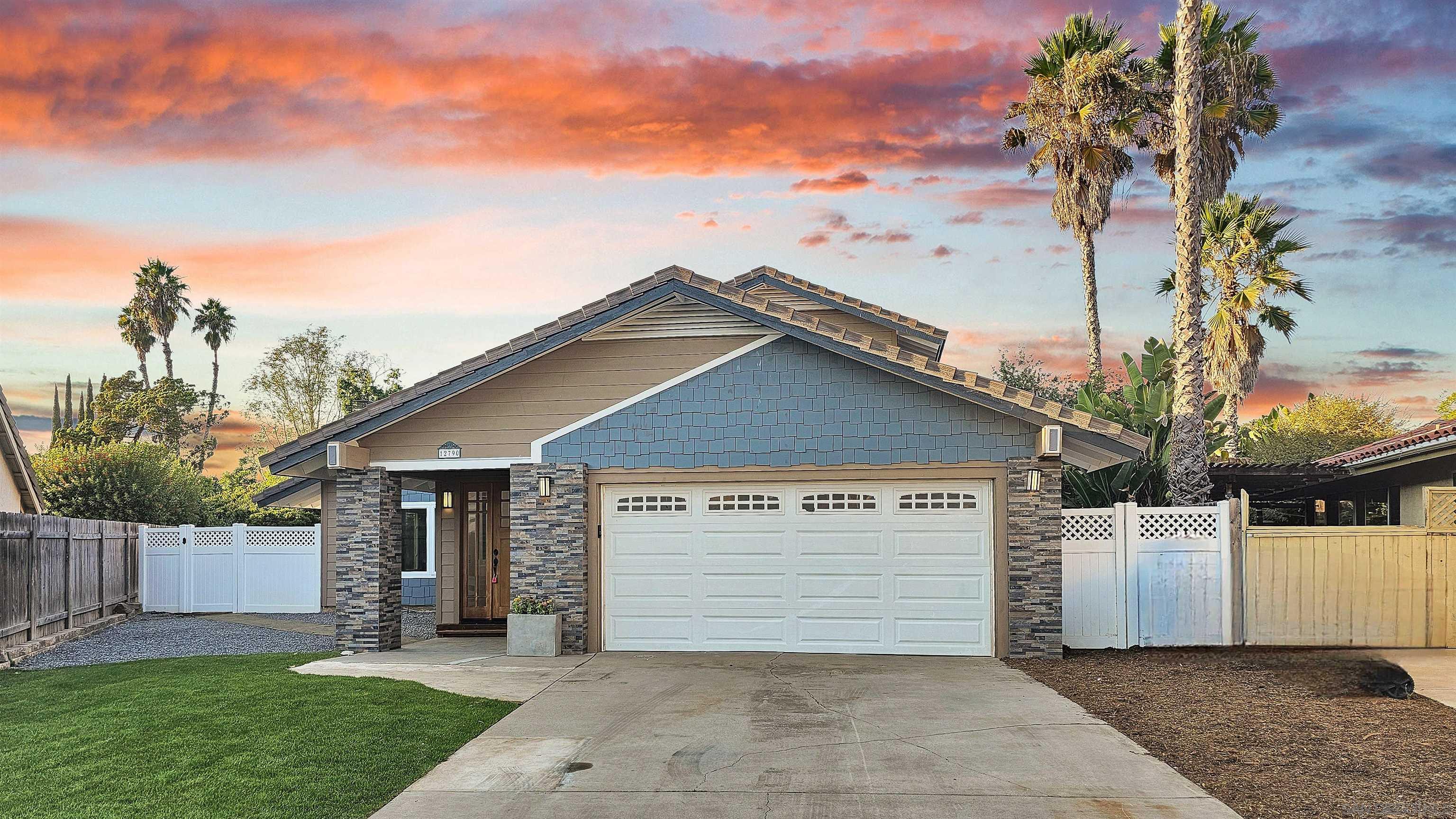 a view of a house with a yard and garage