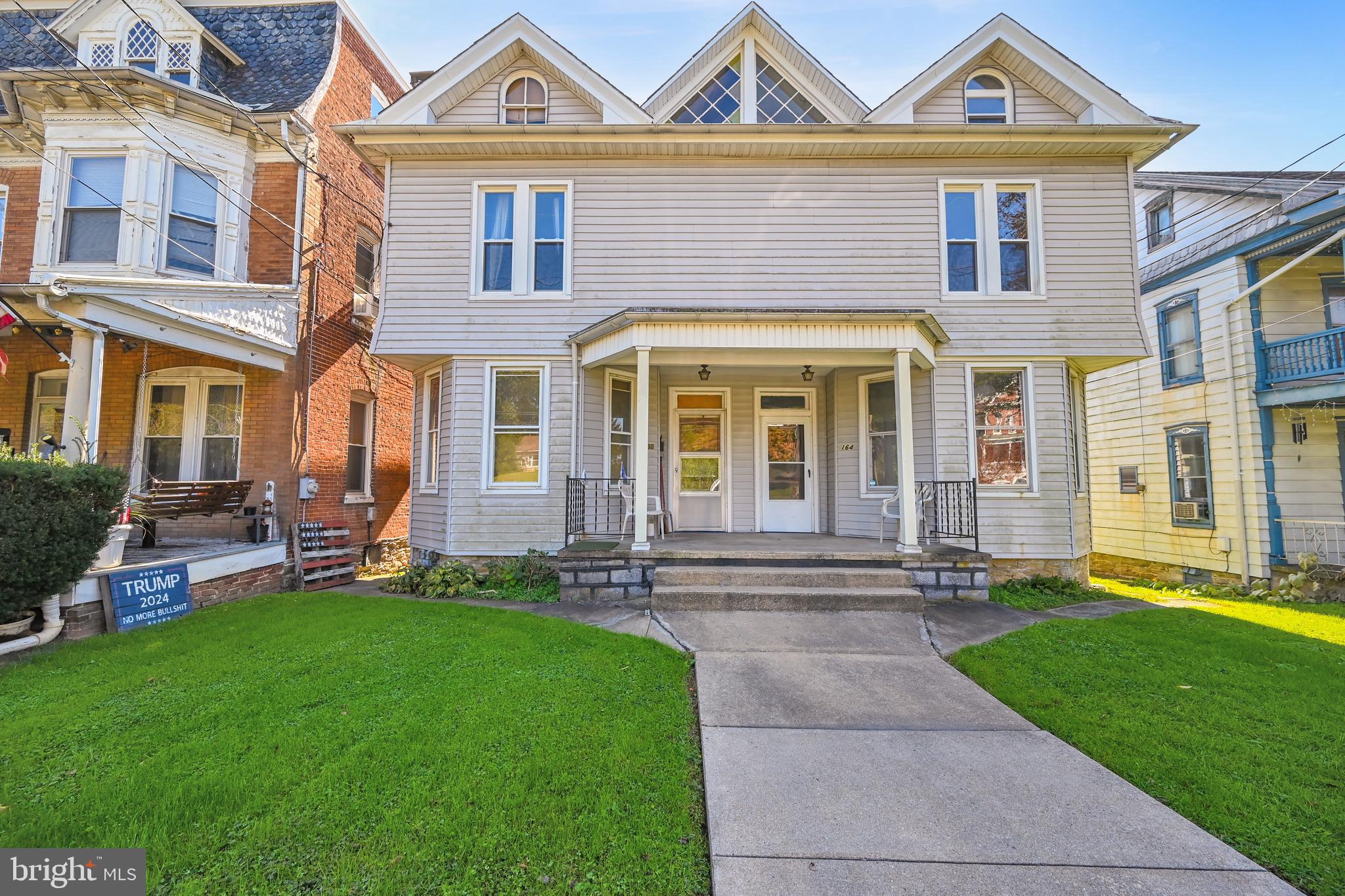 a front view of a house with a yard