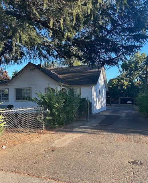 a front view of house with yard and trees around