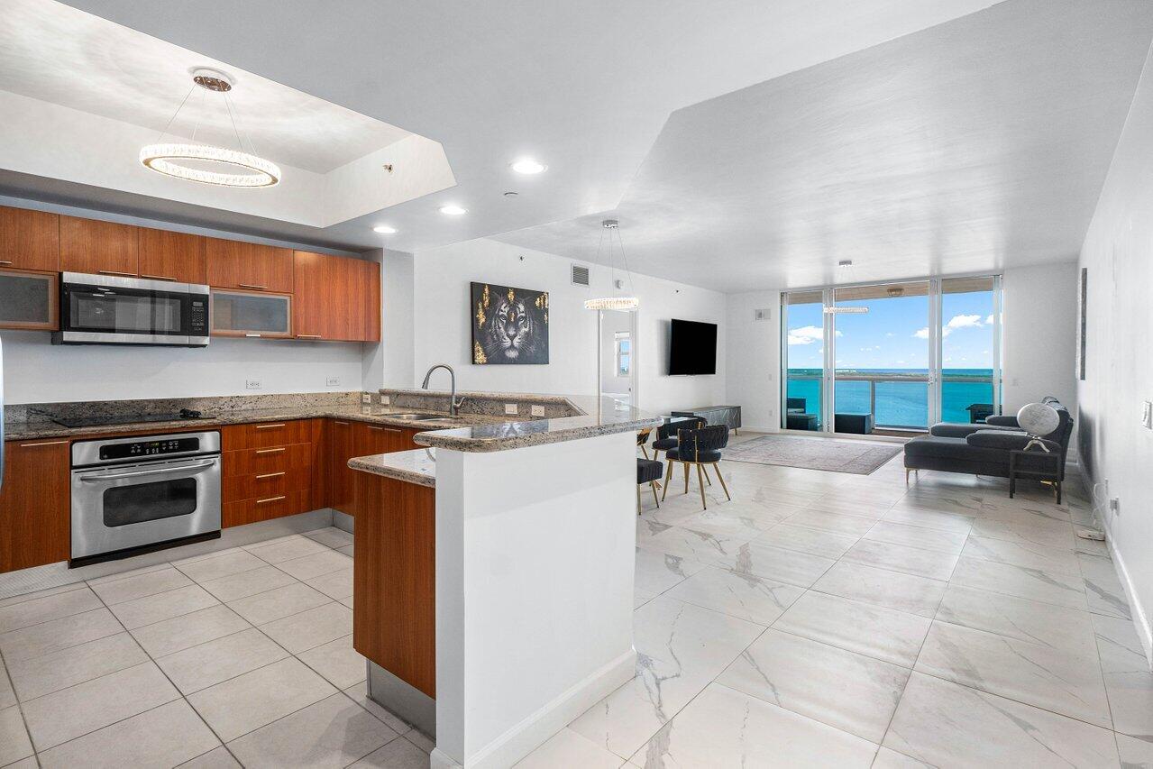 a kitchen with stainless steel appliances granite countertop a stove and a sink