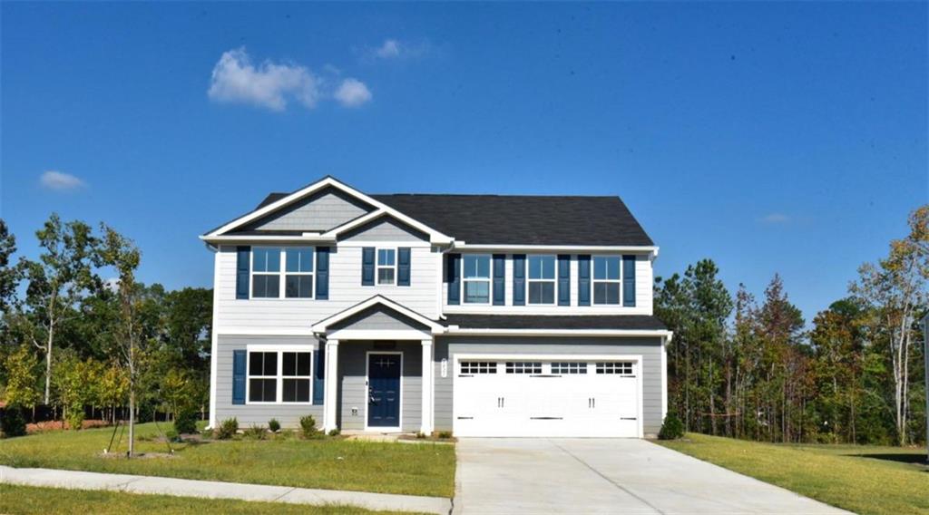 a front view of a house with a yard