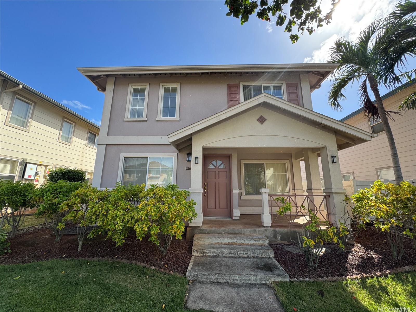 a front view of a house with a garden