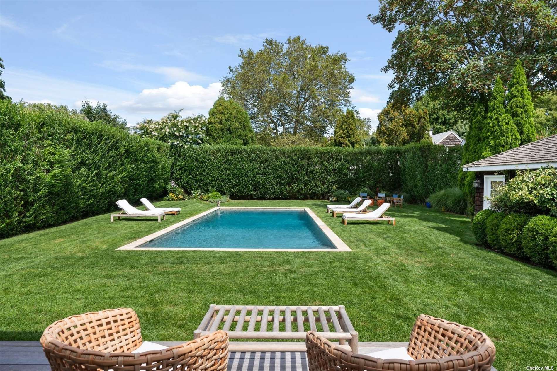 a view of a wooden deck and a yard