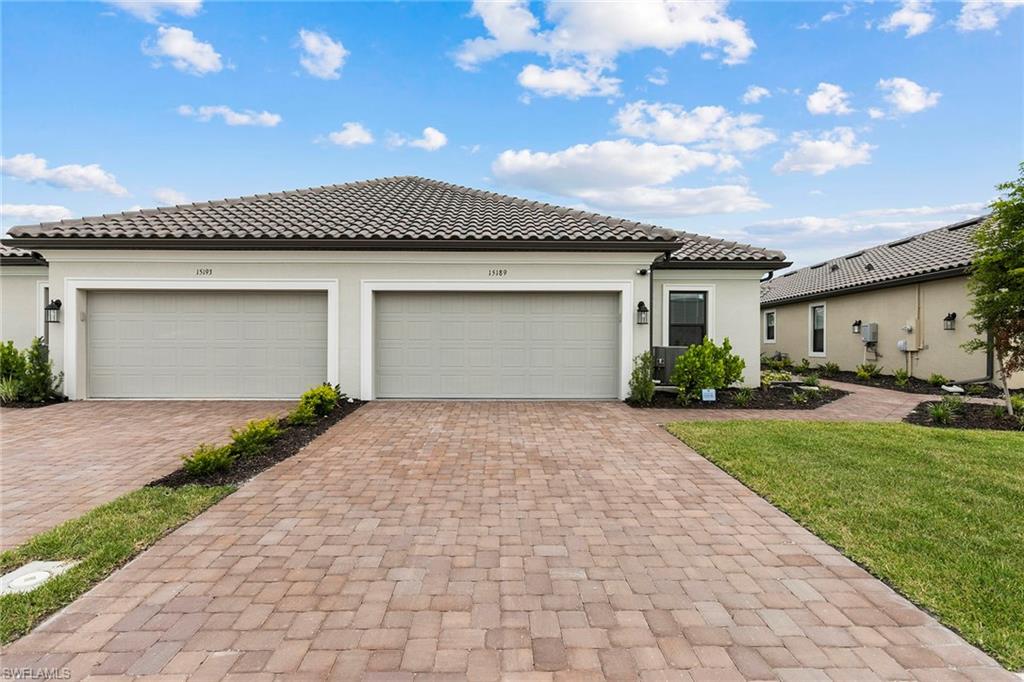 a front view of a house with a yard and garage