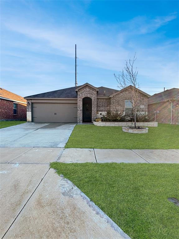 a front view of a house with a garden and yard