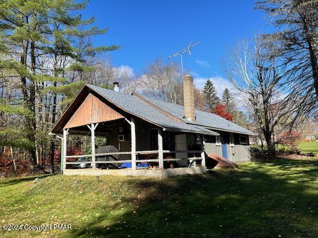 a view of a house with backyard porch and sitting area