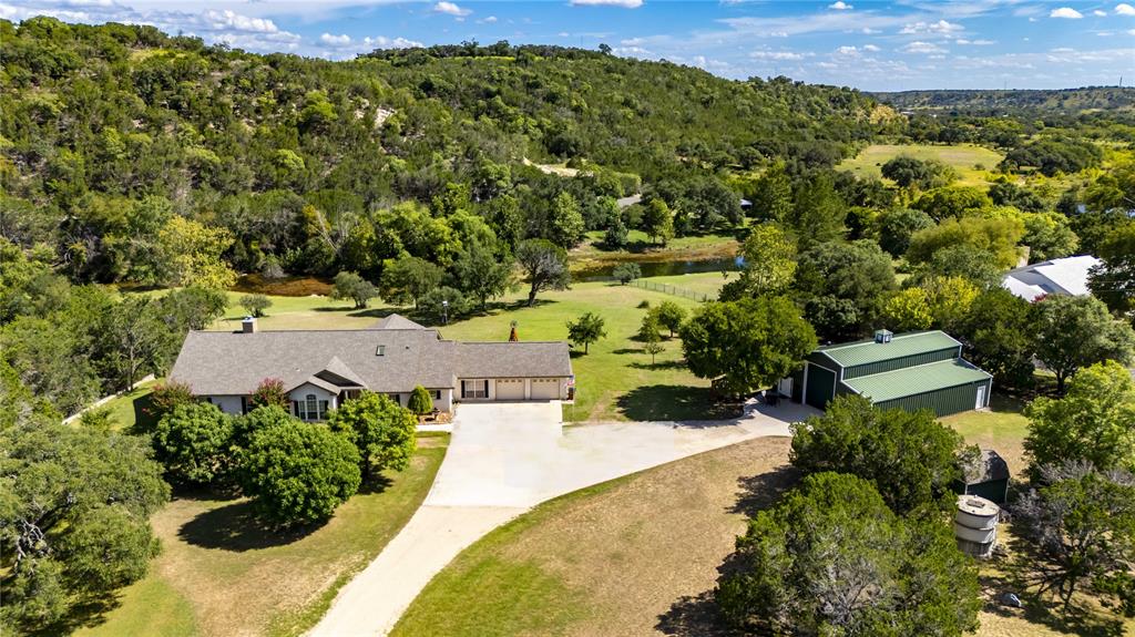 an aerial view of a house with a yard