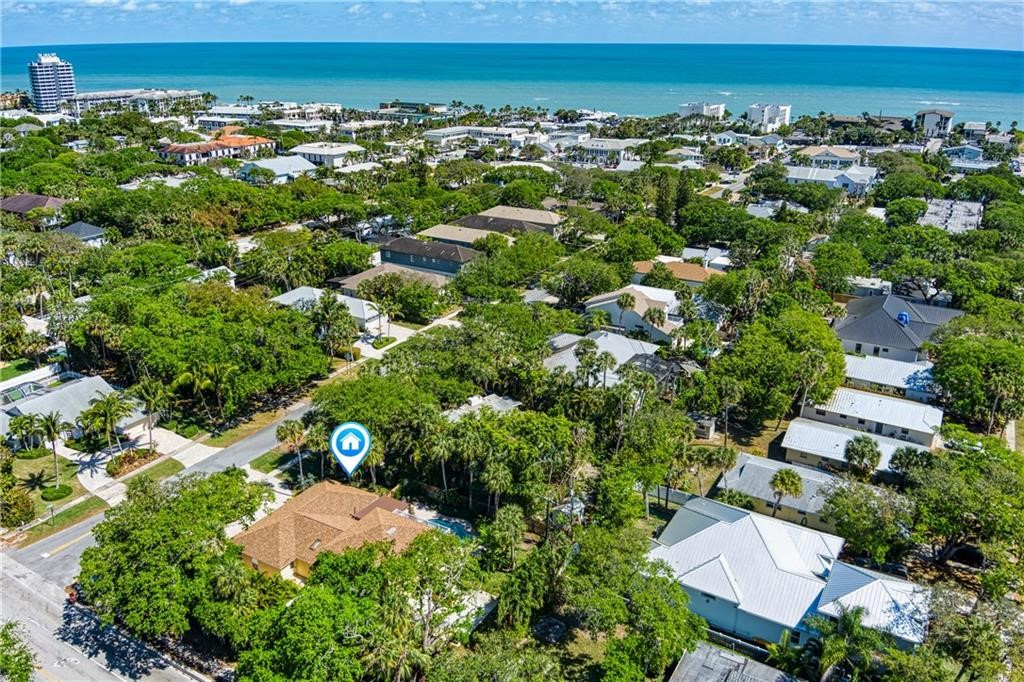 an aerial view of a residential houses with a yard