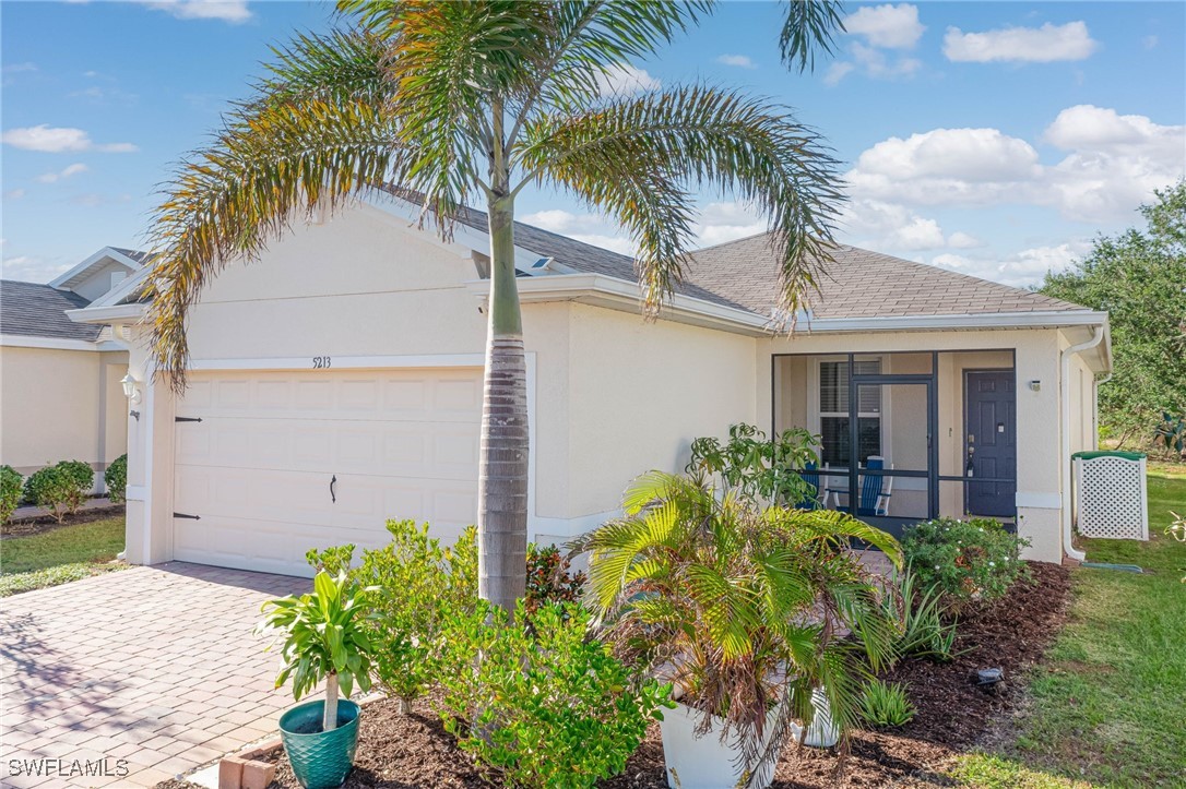 a view of a house with a small yard and palm trees