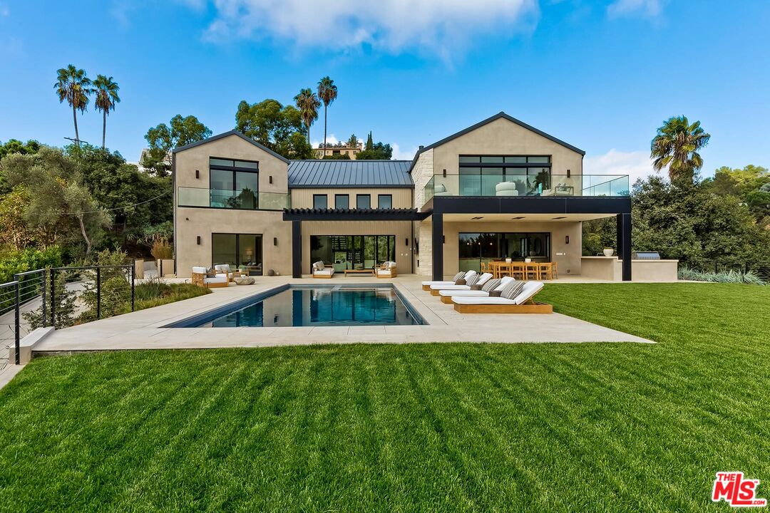 a view of an house with swimming pool and garden