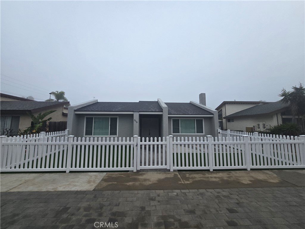 a view of a house with a wooden fence