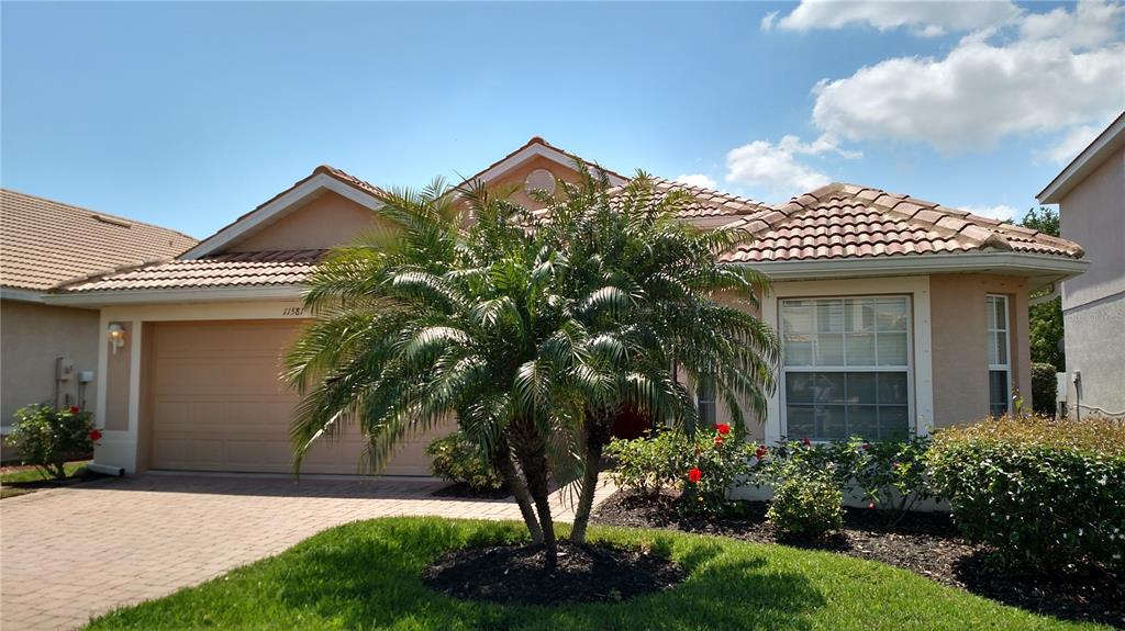 a front view of a house with a garden