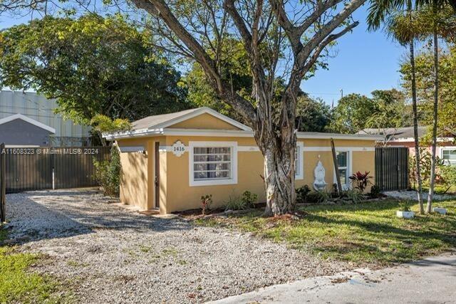 a front view of house with yard space and trees around