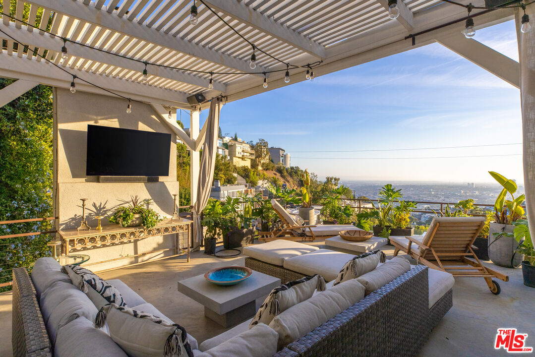 a terrace with outdoor seating and city view