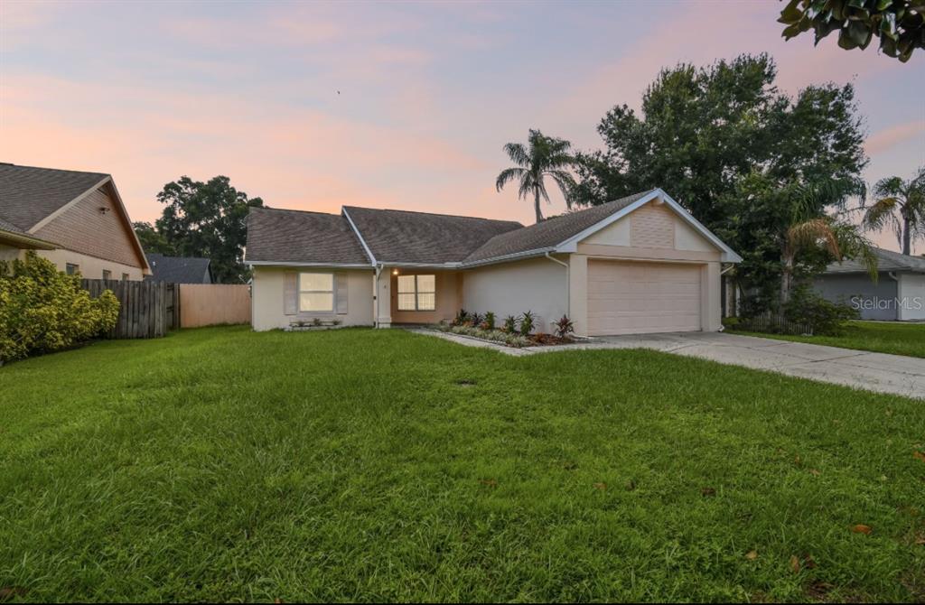 a front view of house with yard and green space