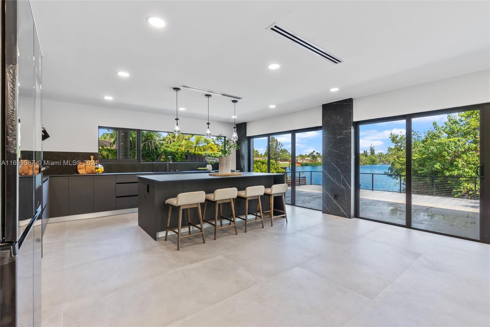 a kitchen with stainless steel appliances dining table chairs and a large window